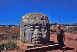 man with giant Olmec head