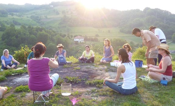 group meditation on sunny hilltop