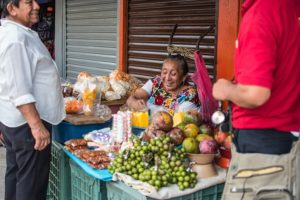 Mexican woman selling fruit in market